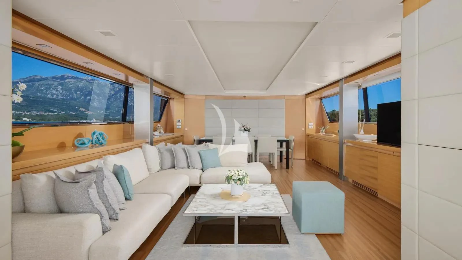 a living room with a couch and a table aboard PERTULA Yacht for Sale