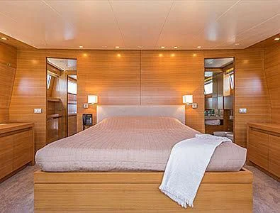 a bedroom with a bed aboard PERTULA Yacht for Sale