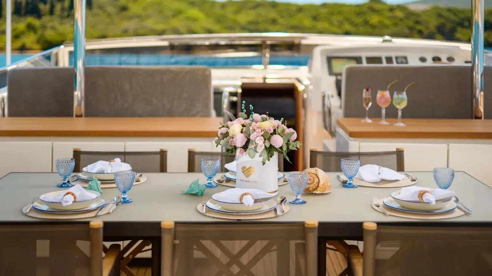 a table set with plates and glasses aboard PERTULA Yacht for Sale