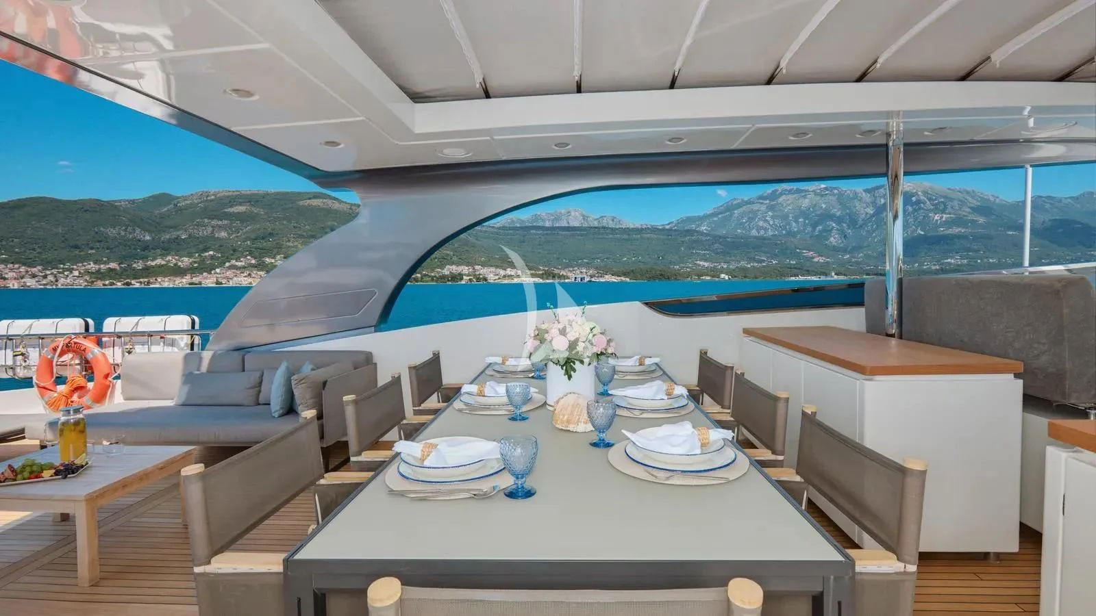a table with plates and cups on it aboard PERTULA Yacht for Sale