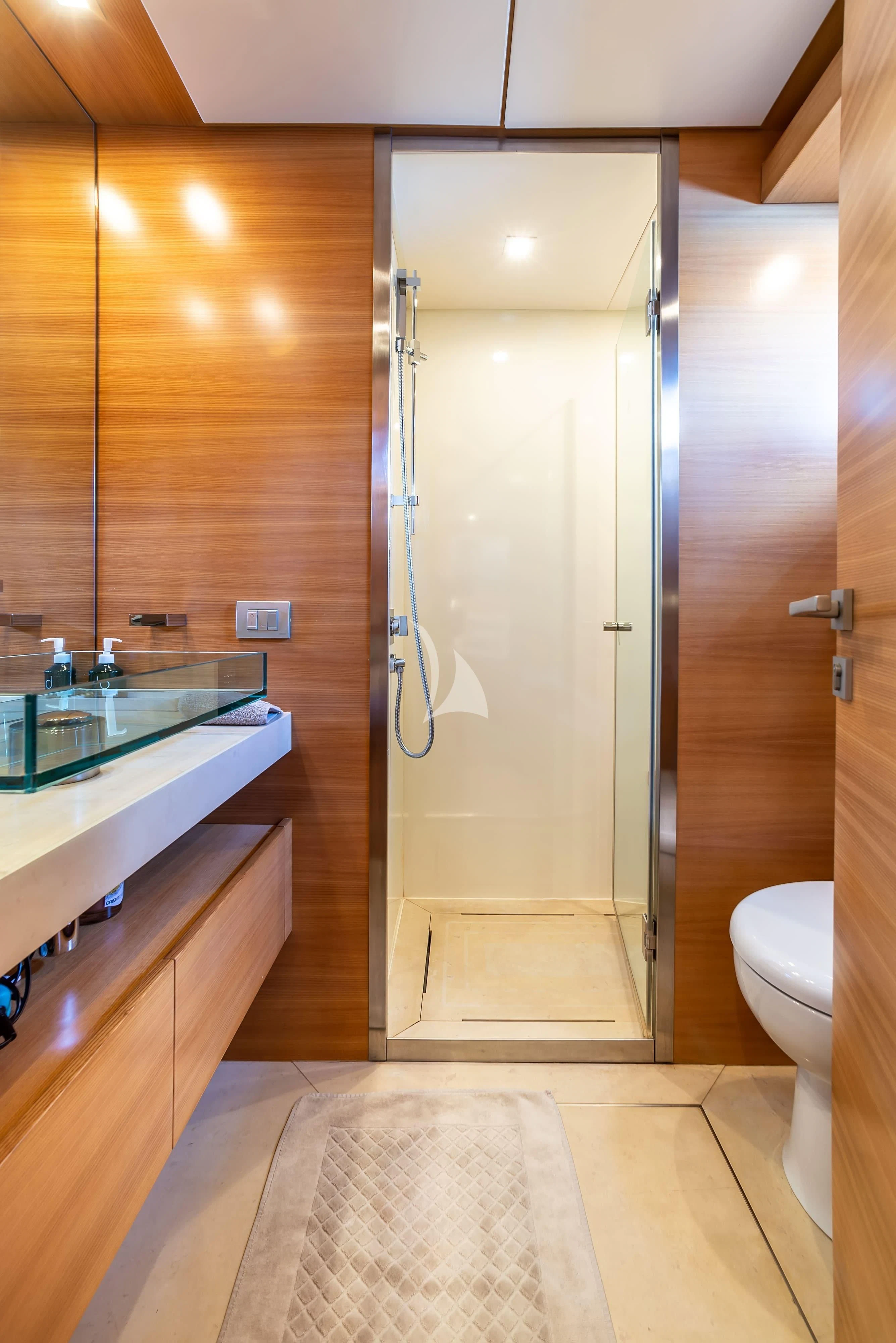 a bathroom with a glass shower door aboard PERTULA Yacht for Sale