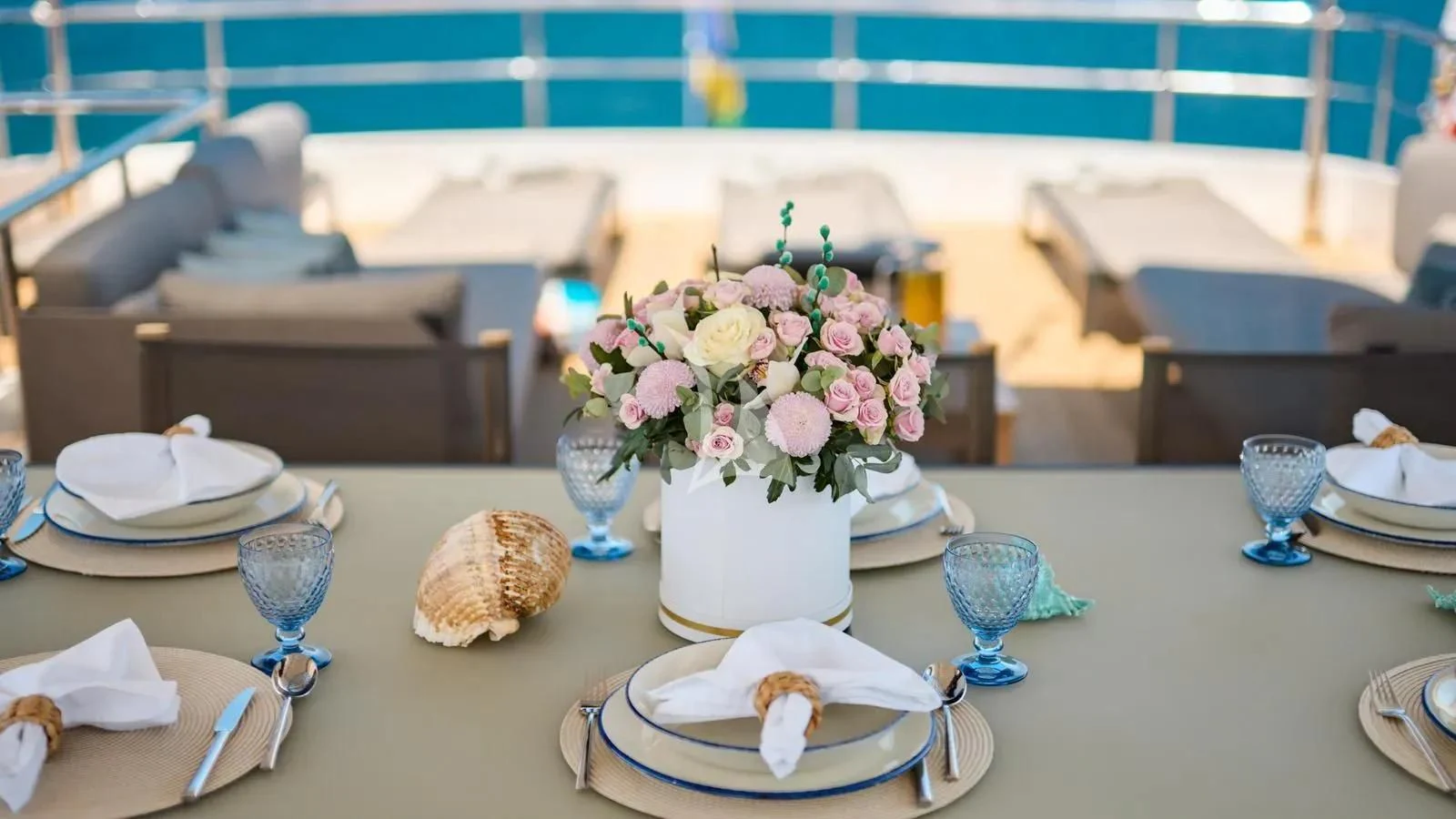 a table with plates and glasses aboard PERTULA Yacht for Sale