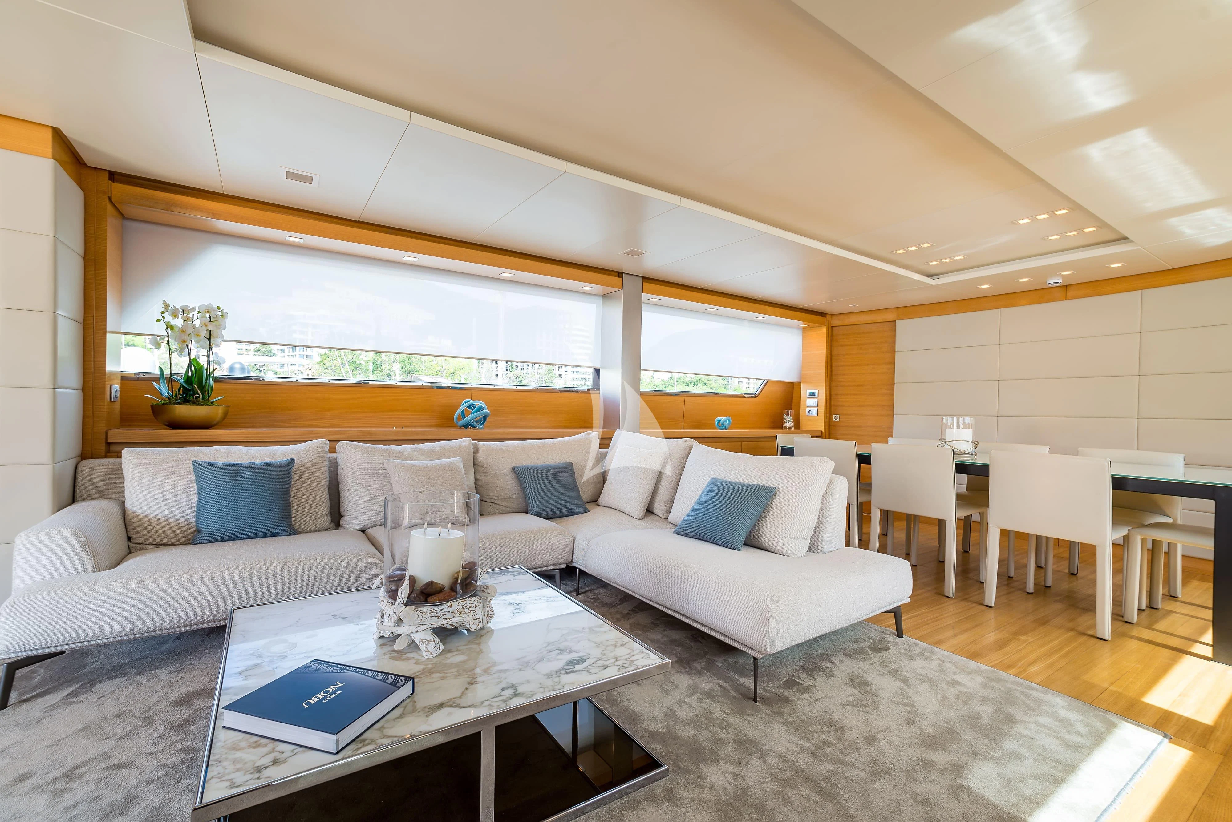 a living room with a couch and a table aboard PERTULA Yacht for Sale