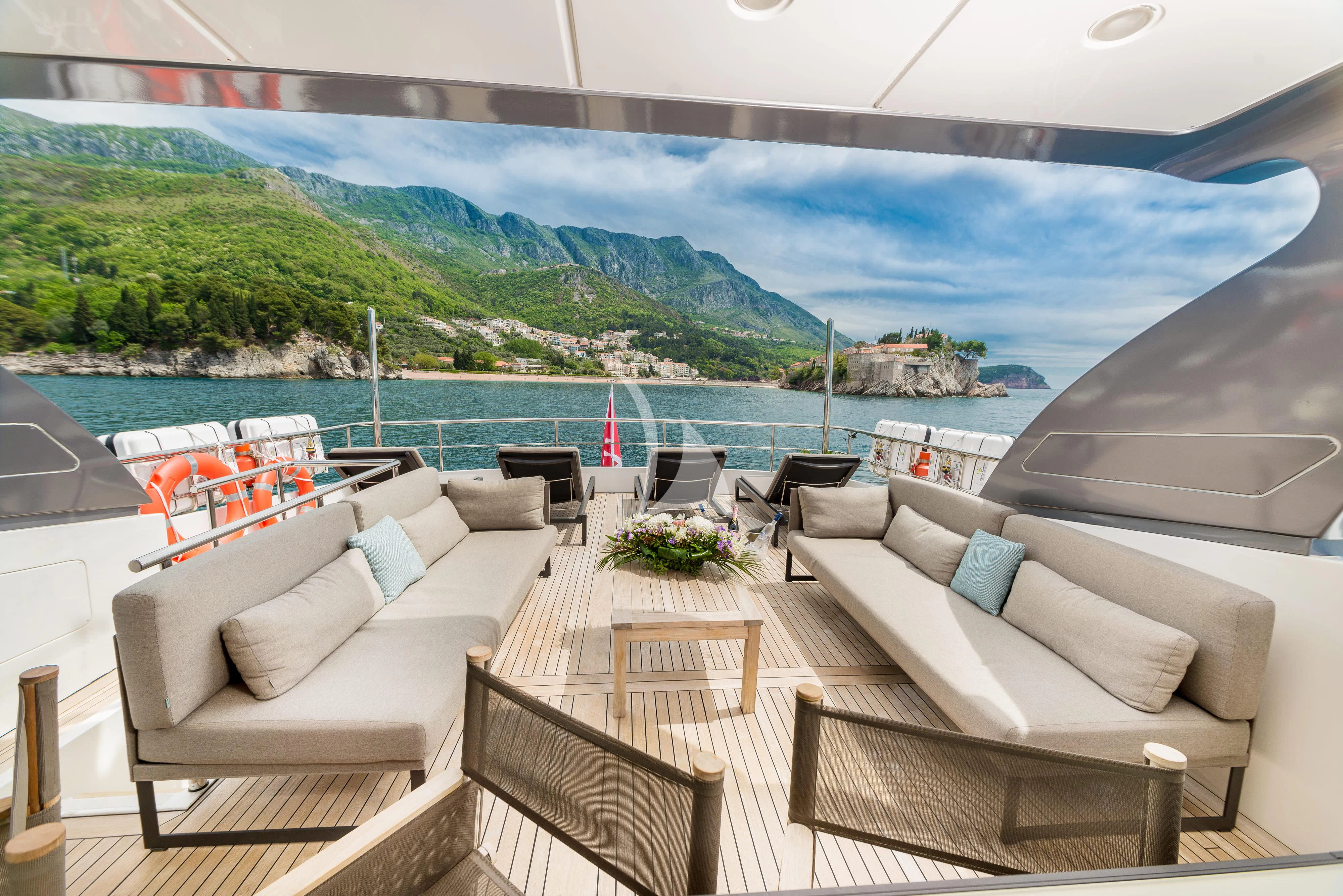 a room with a view of a beach and a large body of water aboard PERTULA Yacht for Sale