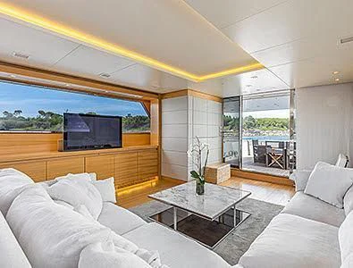 a living room with a large screen aboard PERTULA Yacht for Sale