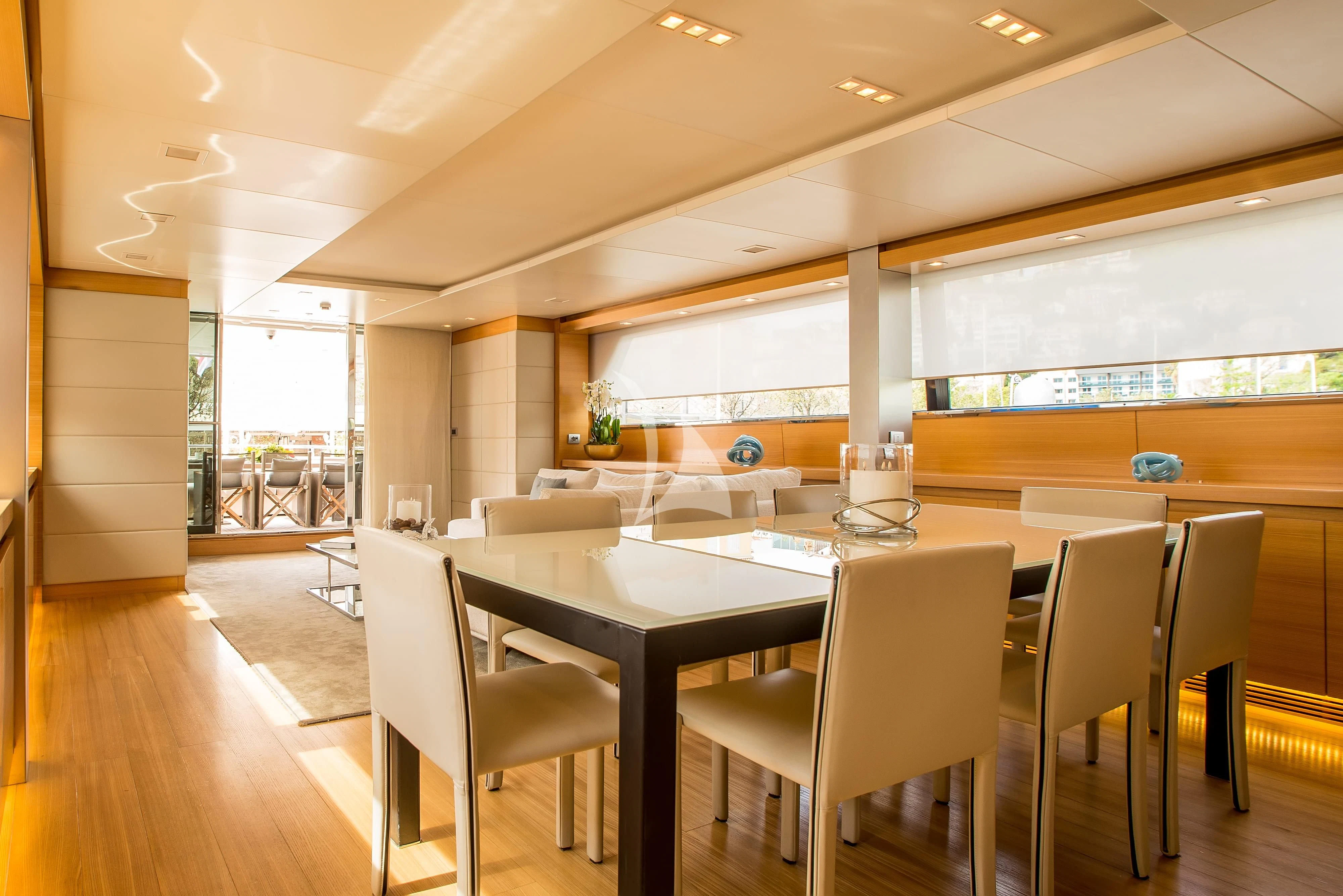 a large room with tables and chairs aboard PERTULA Yacht for Sale