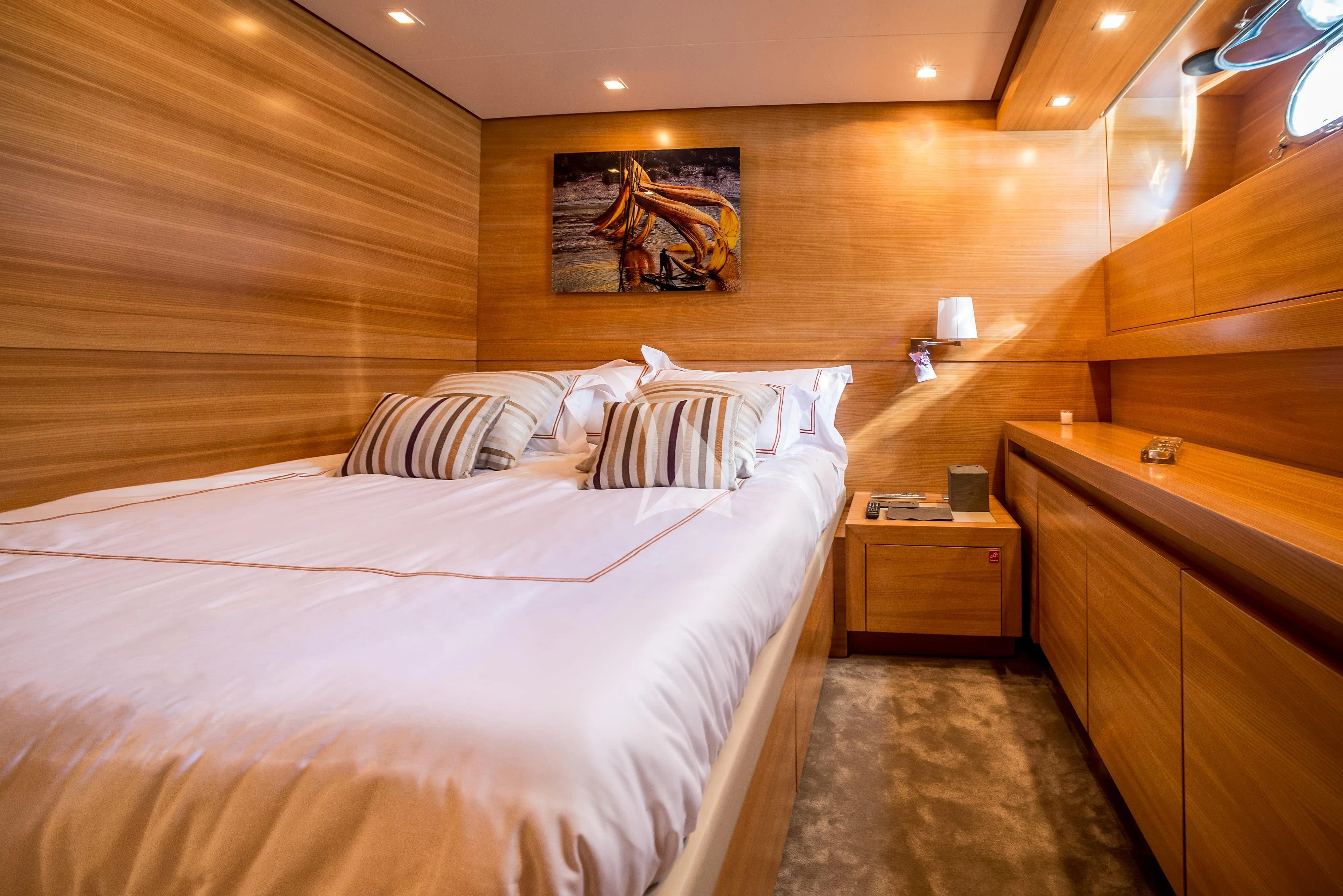 a room with a bed and a dresser aboard PERTULA Yacht for Sale
