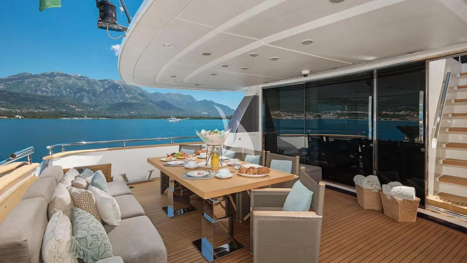 a room with a table and chairs aboard PERTULA Yacht for Sale