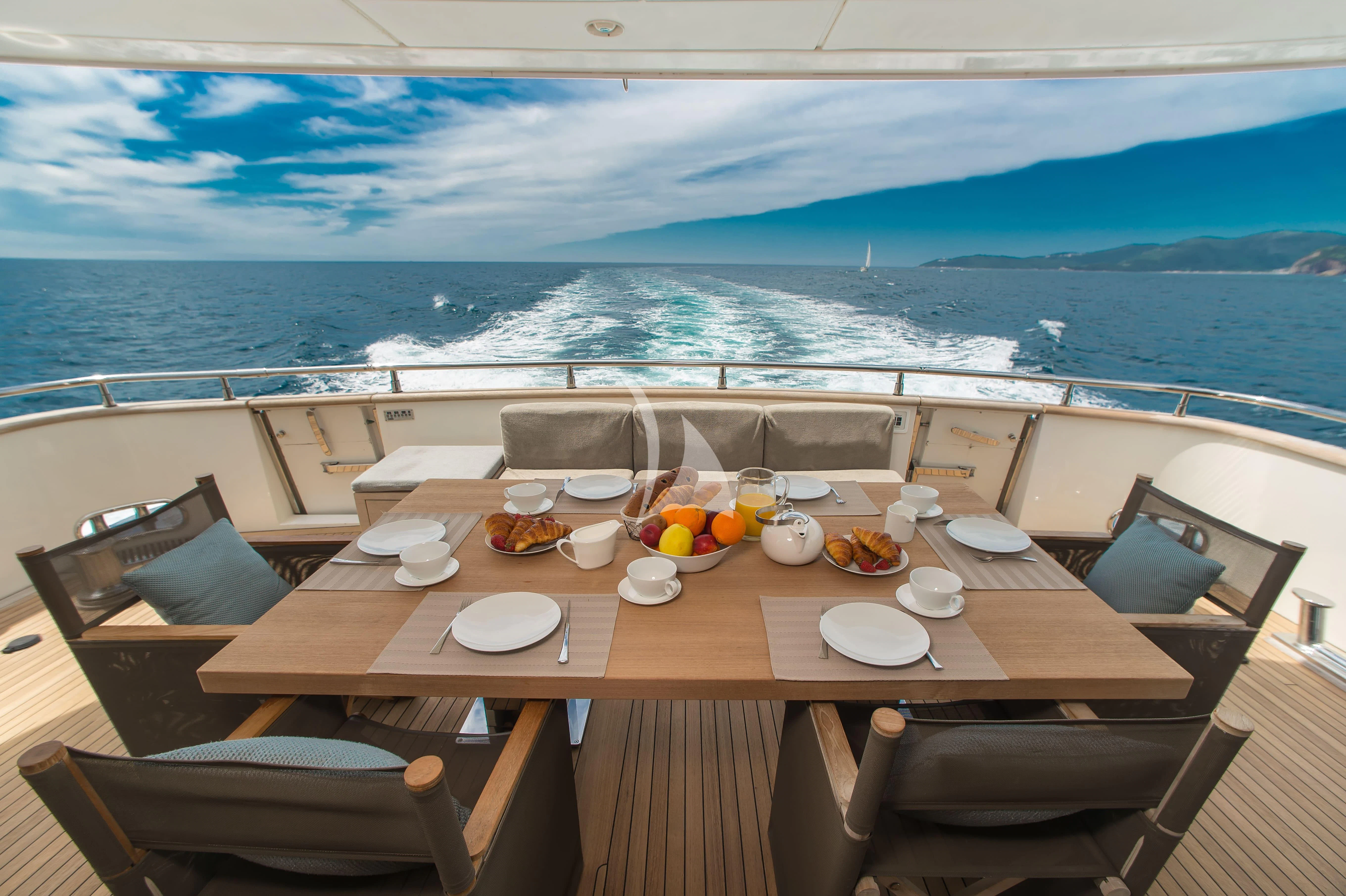 a table with food on it aboard PERTULA Yacht for Sale
