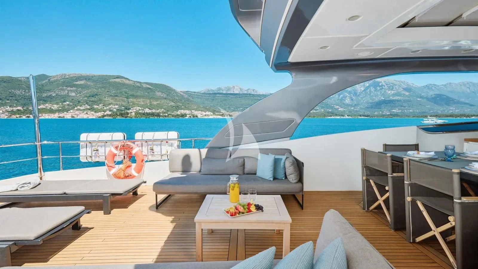 a room with a couch and a table and a pool aboard PERTULA Yacht for Sale