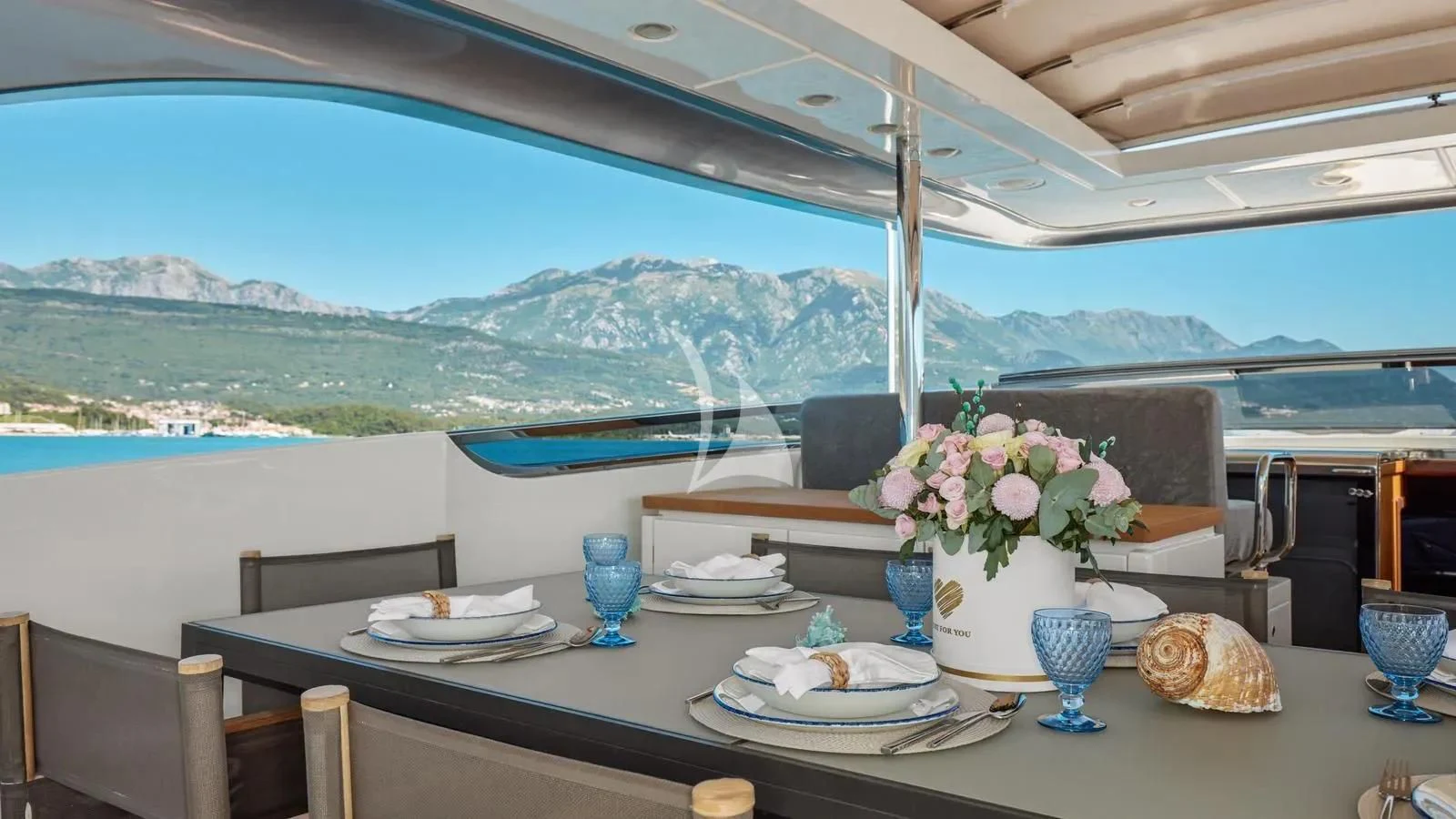 a table with plates and food on it aboard PERTULA Yacht for Sale