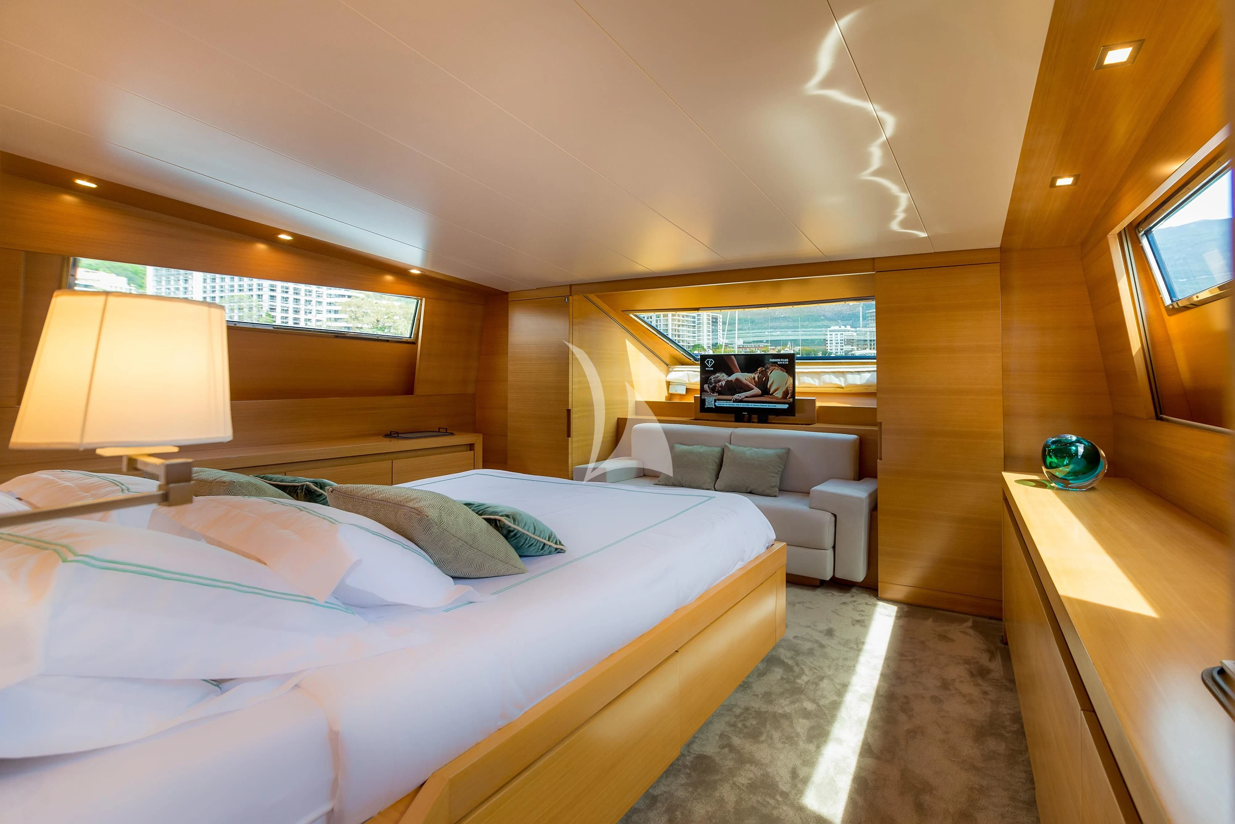 a bedroom with a bed and a desk aboard PERTULA Yacht for Sale
