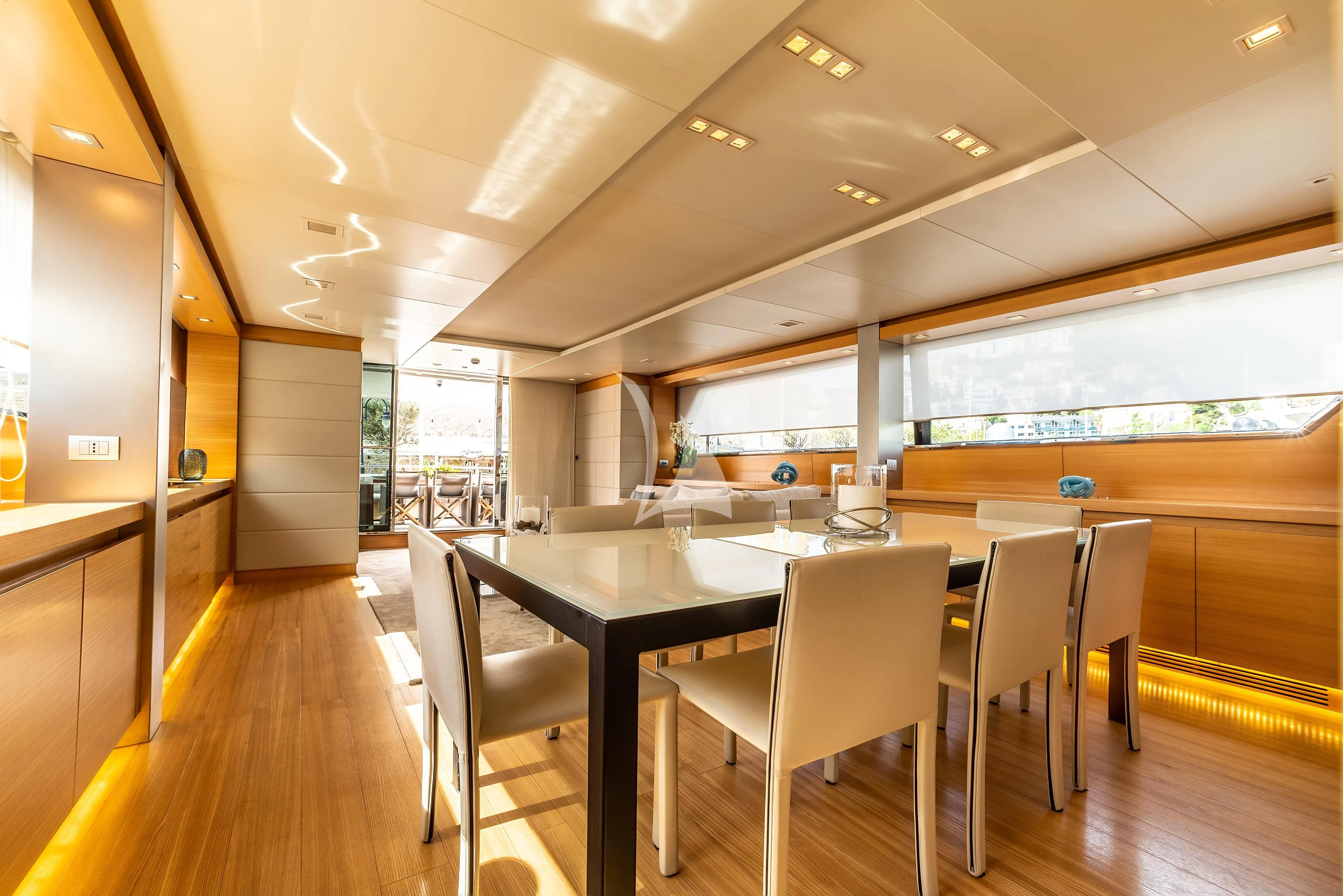 a large room with tables and chairs aboard PERTULA Yacht for Sale