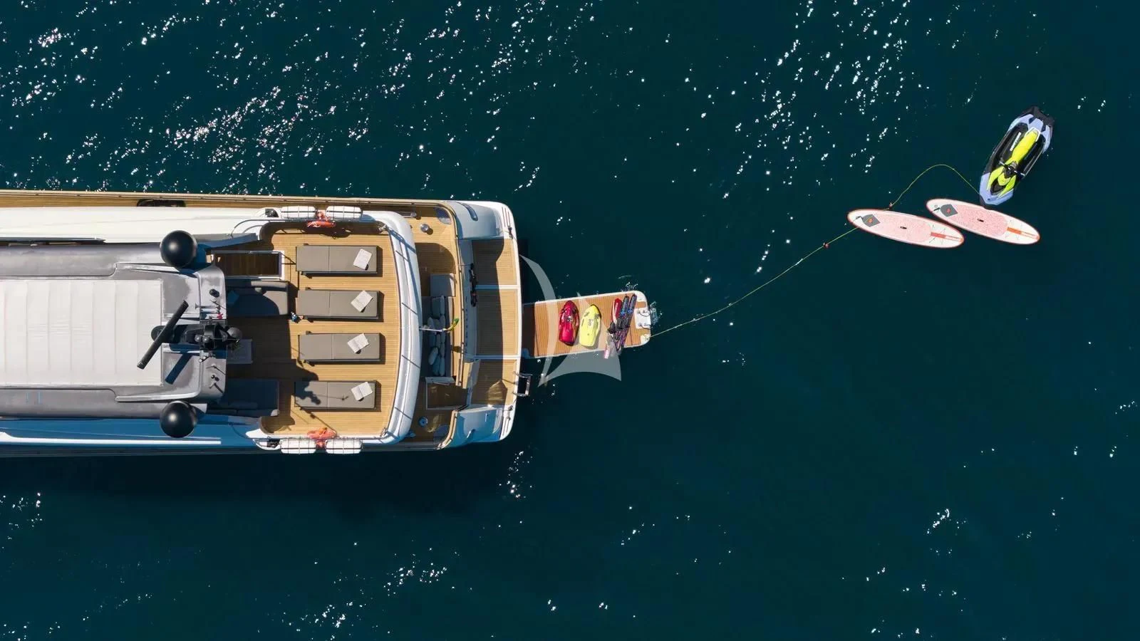 a person parachuting from a boat in the water aboard PERTULA Yacht for Sale