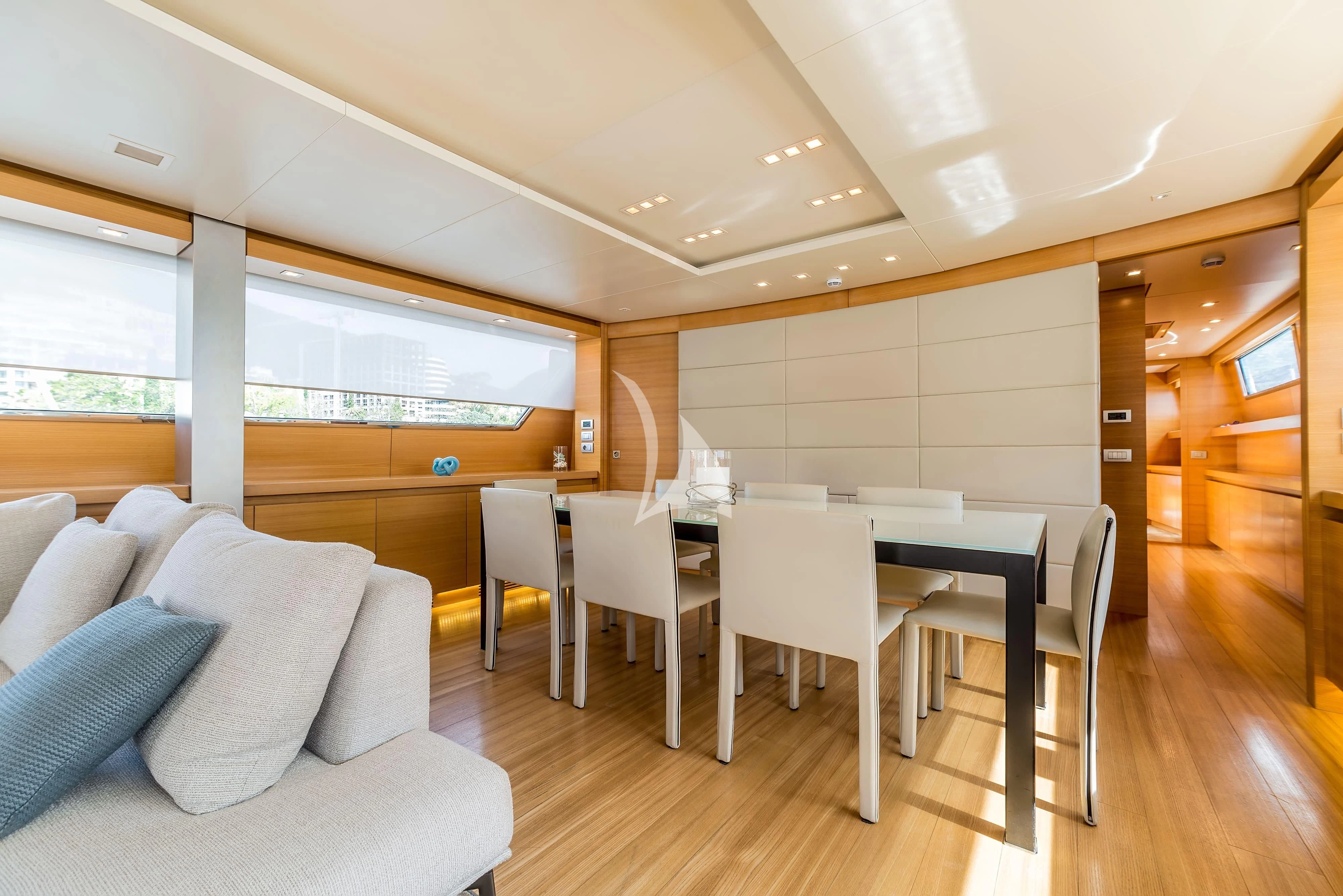 a room with a table and chairs aboard PERTULA Yacht for Sale