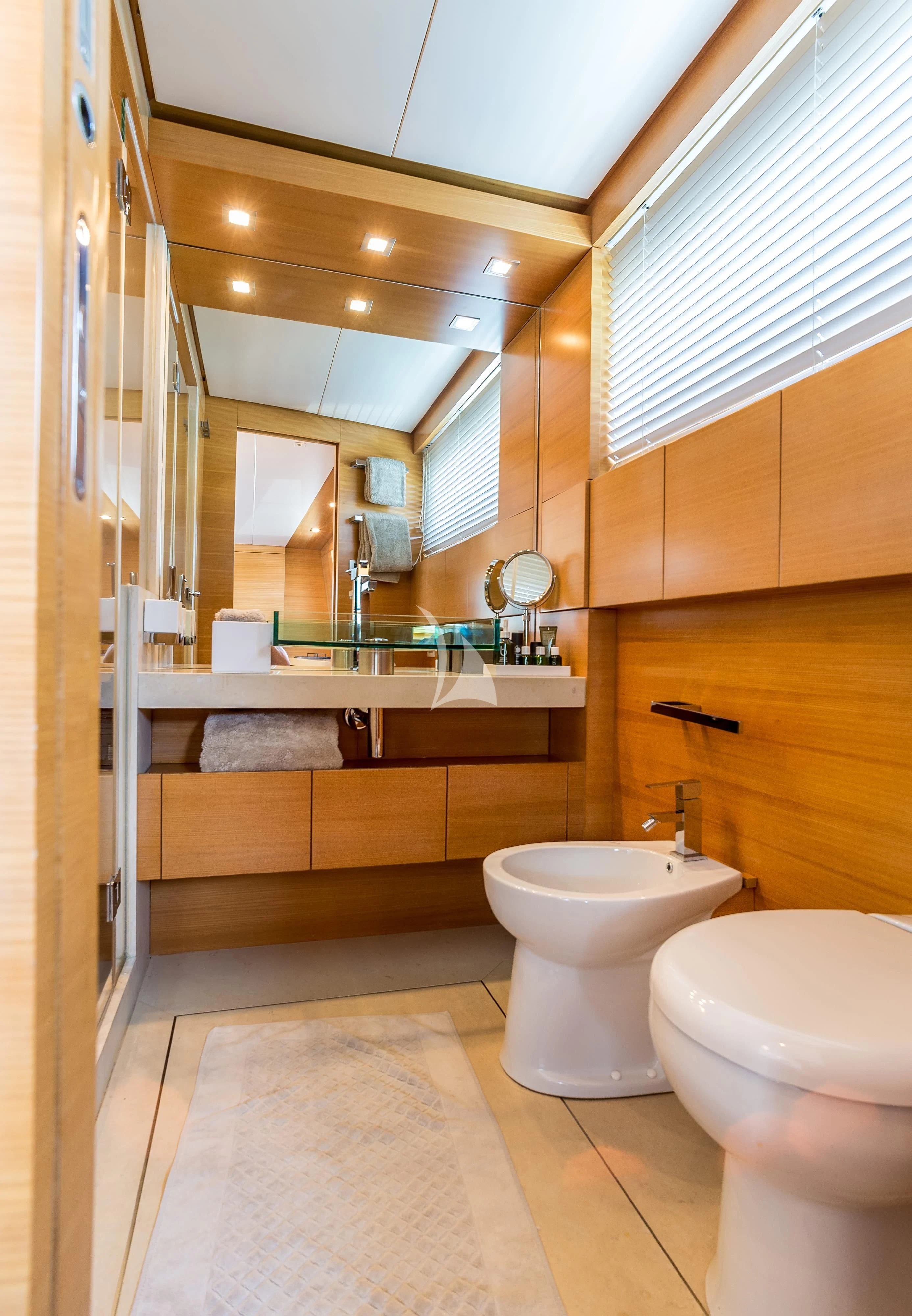 a bathroom with a toilet and a sink aboard PERTULA Yacht for Sale