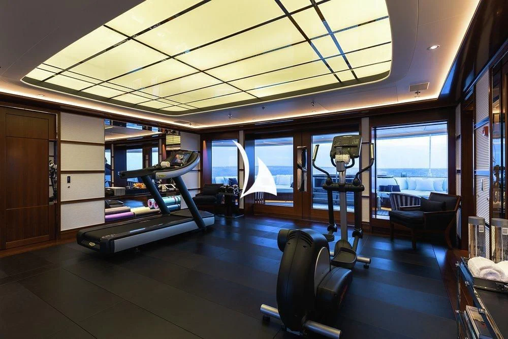 a room with a large window and a table with chairs aboard SOPHIA Yacht for Sale