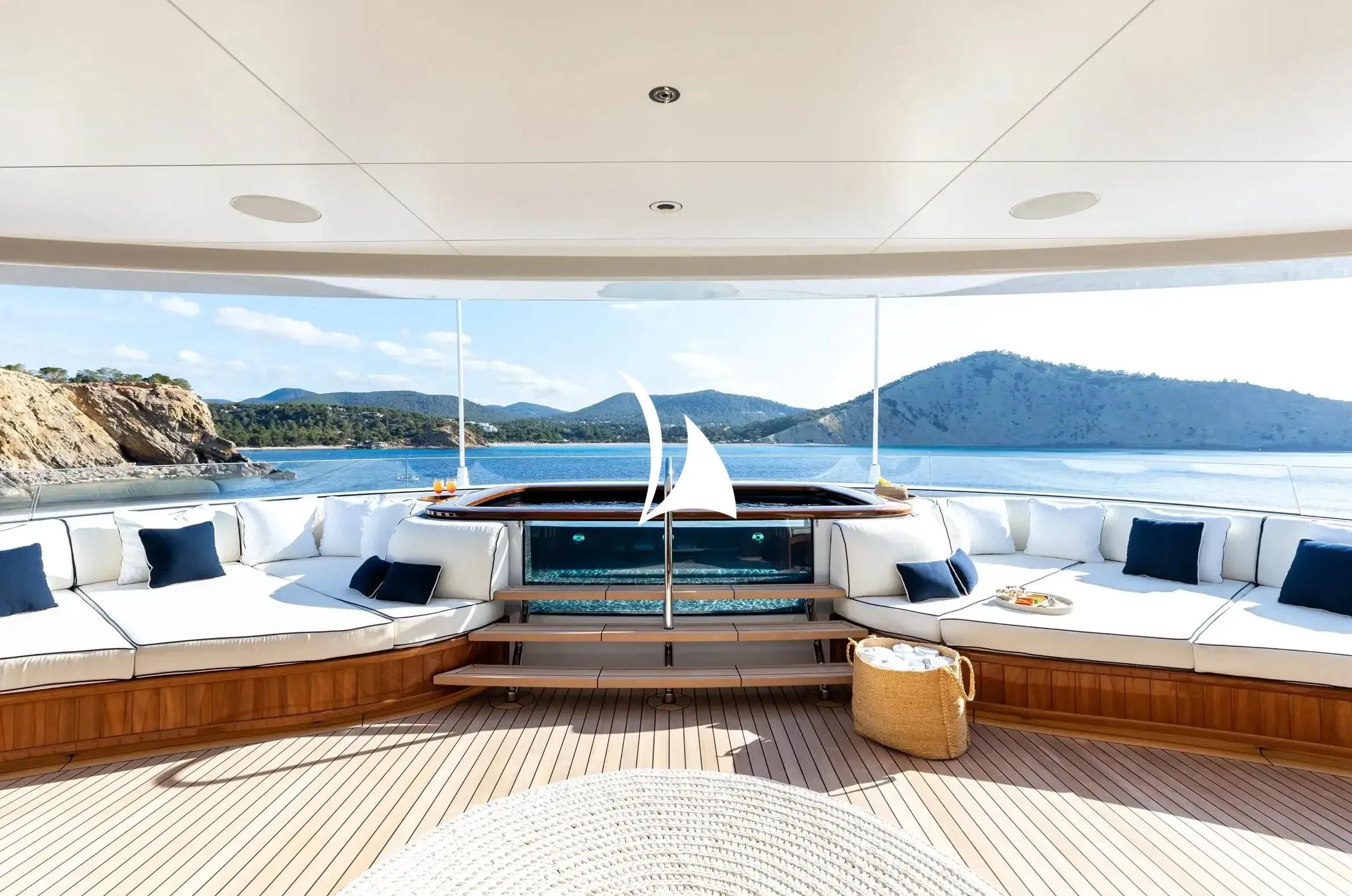 a room with a view of the water and mountains in the background aboard SOPHIA Yacht for Sale