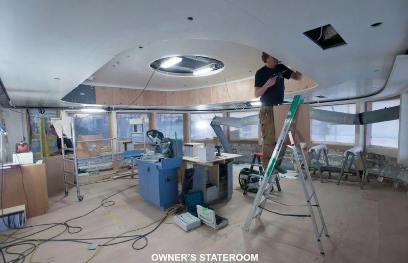 a person working on a project aboard SOPHIA Yacht for Sale