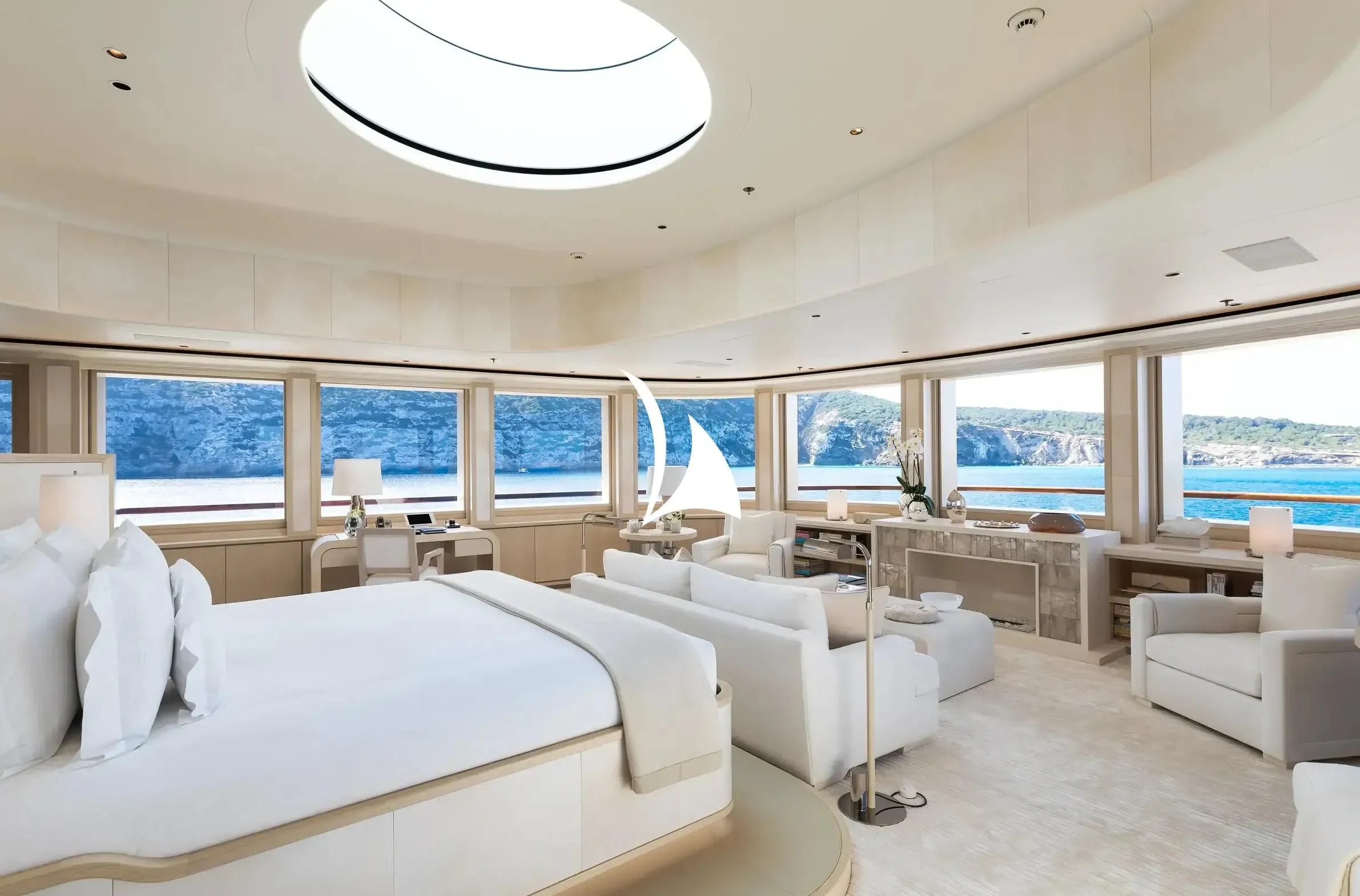a room with a large white couch and a large window aboard SOPHIA Yacht for Sale