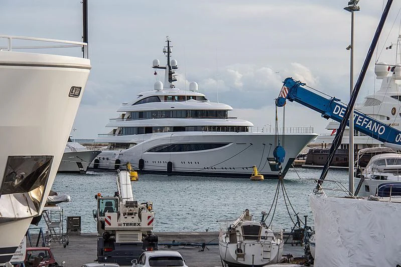 a large white ship docked at a port aboard SOPHIA Yacht for Sale
