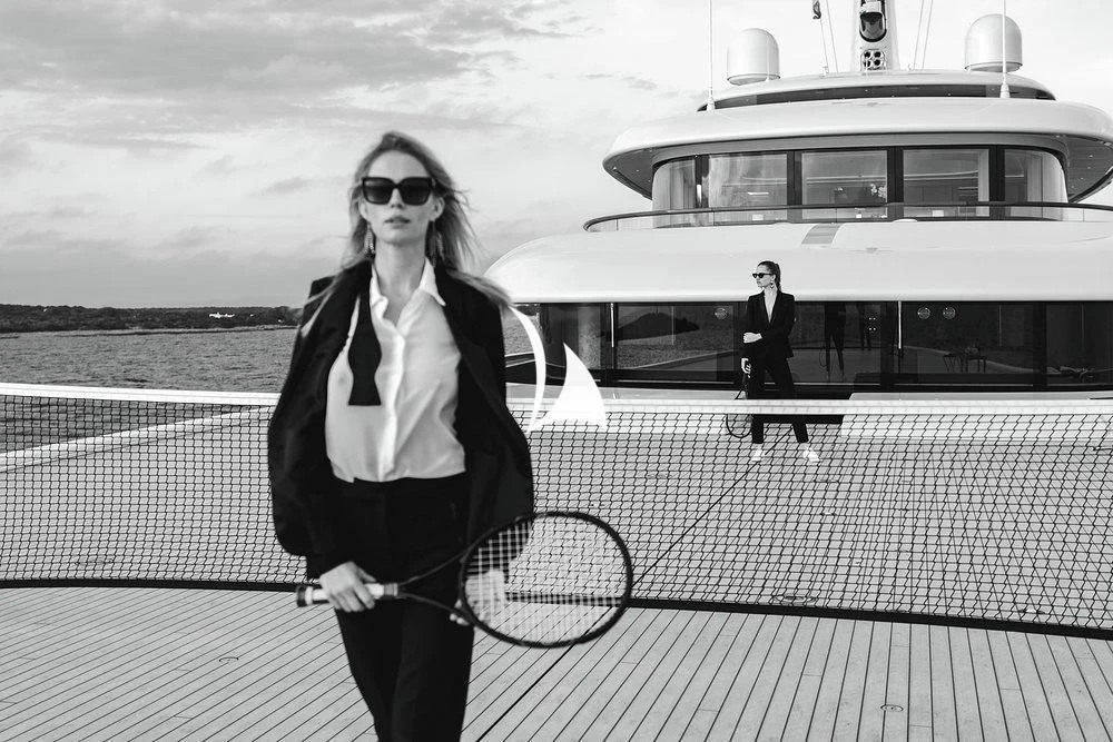a woman holding a tennis racket aboard SOPHIA Yacht for Sale