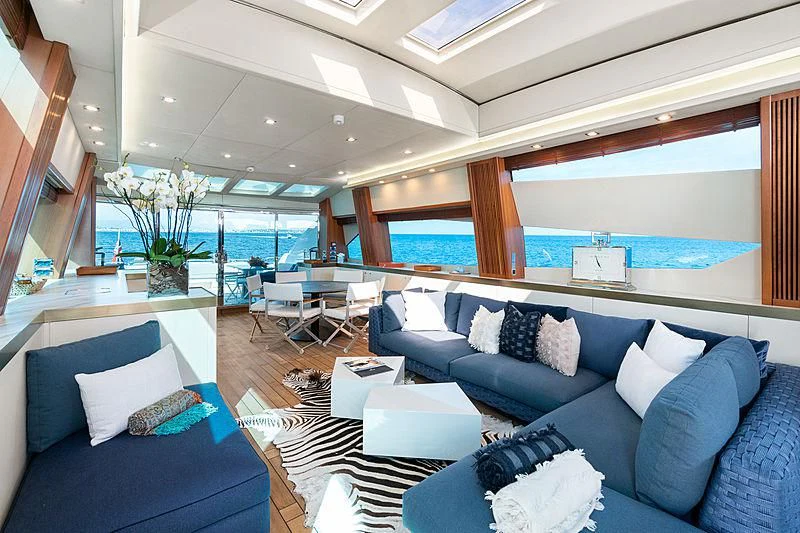 a room with a couch and a table and chairs aboard EYE Yacht for Sale