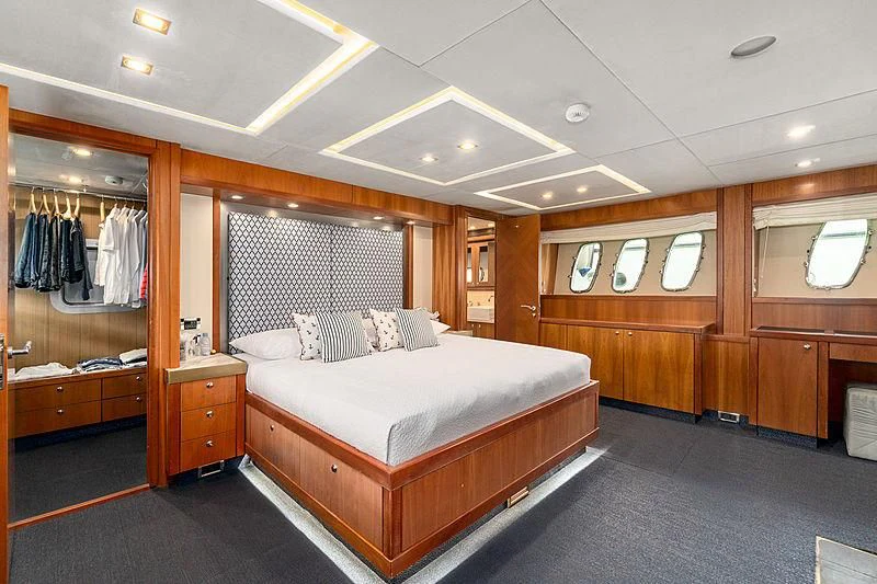 a bedroom with a bed and a closet aboard EYE Yacht for Sale