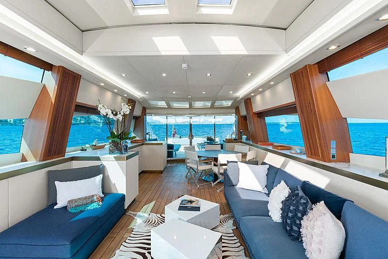 a room with a table chairs and a view of the ocean aboard EYE Yacht for Sale