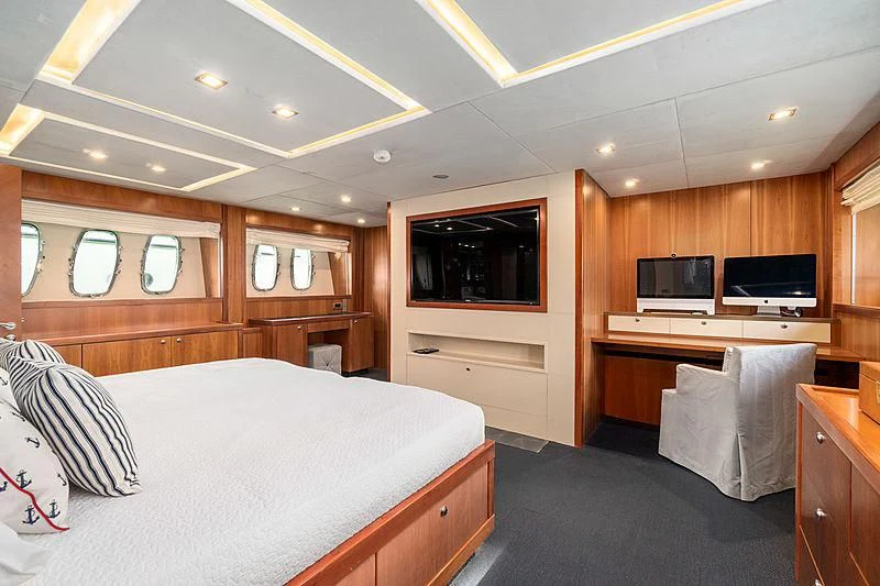 a bedroom with a bed and a tv aboard EYE Yacht for Sale