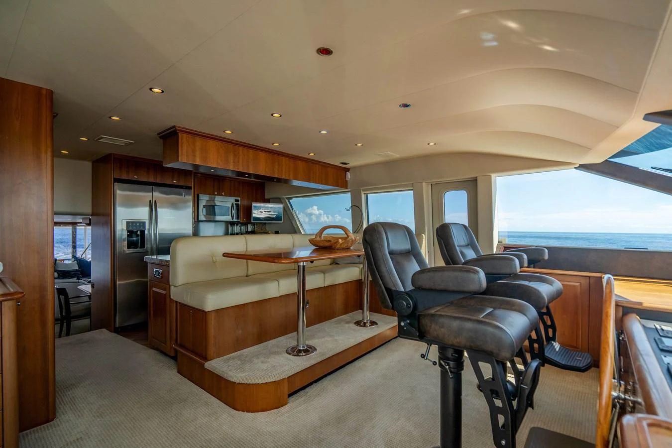 a room with a desk and chairs aboard L'DOR V'DOR Yacht for Sale