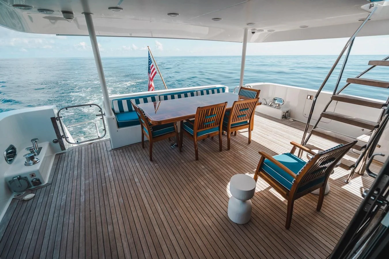 a deck with chairs and tables on it aboard L'DOR V'DOR Yacht for Sale