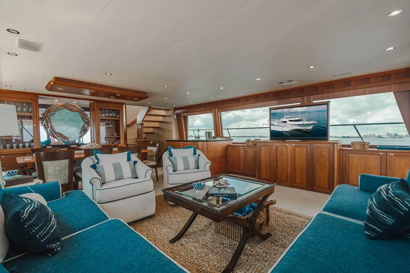a living room with a large wood cabinet and a large window aboard L'DOR V'DOR Yacht for Sale