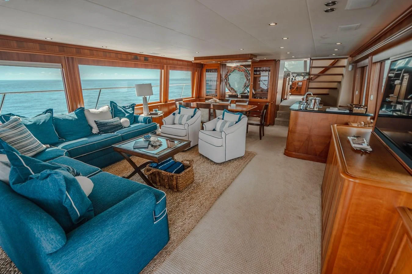 a living room with a blue couch aboard L'DOR V'DOR Yacht for Sale