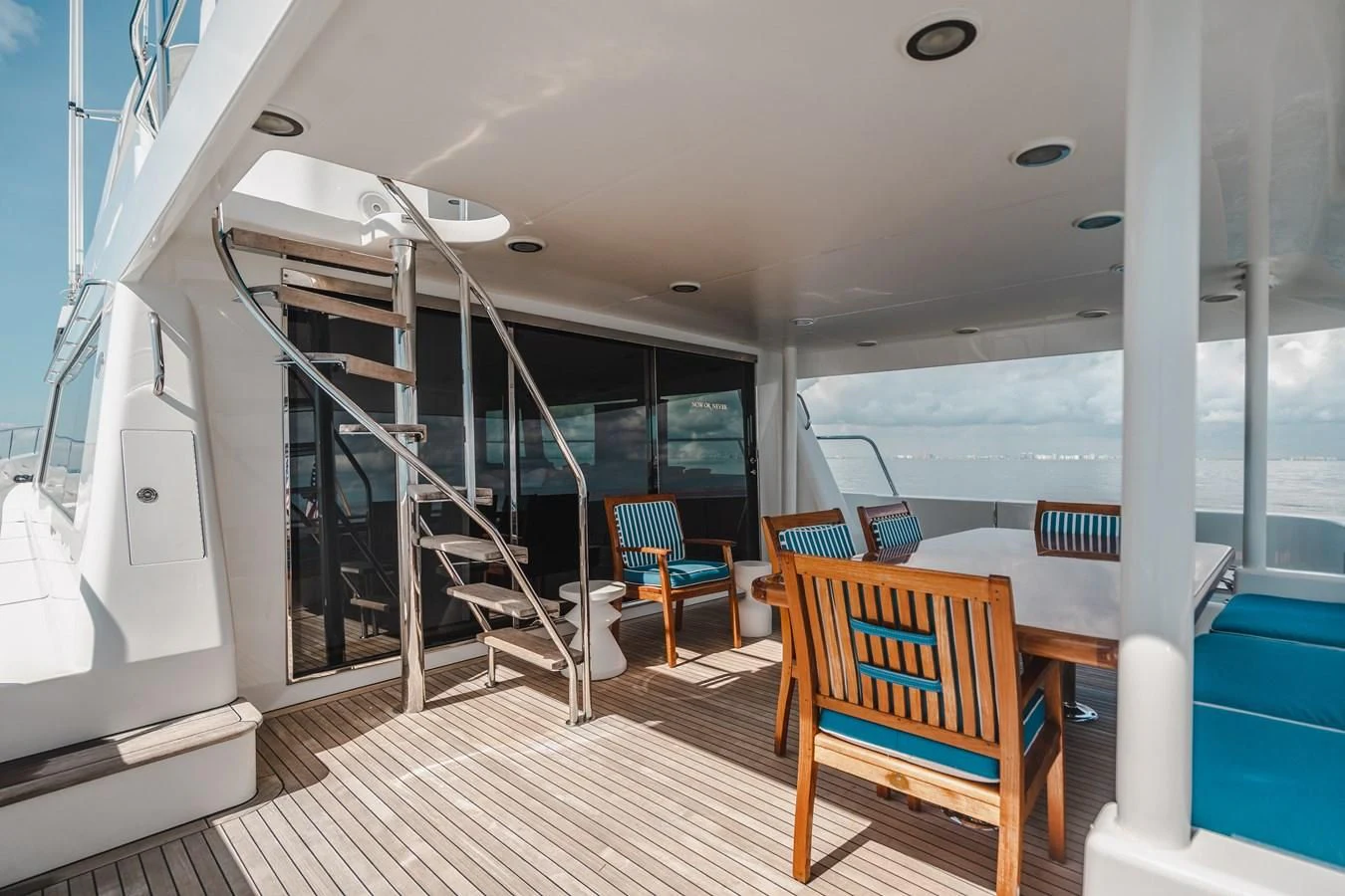 a room with a table chairs and a large glass window aboard L'DOR V'DOR Yacht for Sale