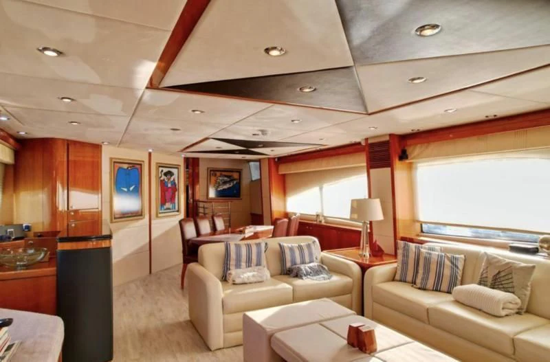 a living room with a couch and a television aboard 'S NOON SOMEWHERE Yacht for Sale