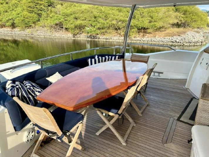 a deck with a boat and chairs on it aboard 'S NOON SOMEWHERE Yacht for Sale