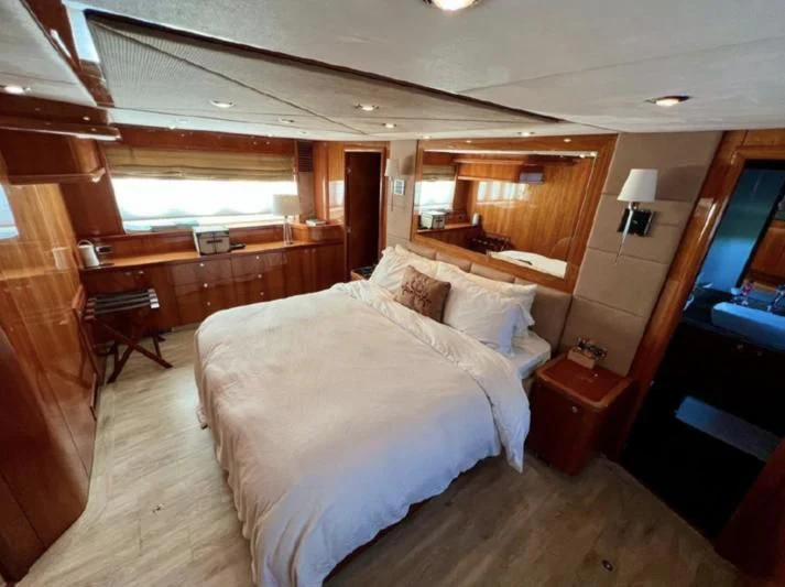 a bedroom with a bed and a desk aboard 'S NOON SOMEWHERE Yacht for Sale