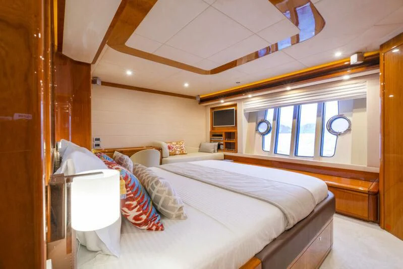 a bedroom with a bed and a window aboard ASTARTE Yacht for Sale