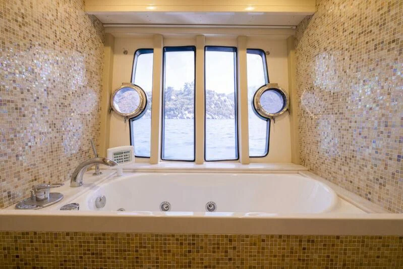a bathroom with a tub and sinks aboard ASTARTE Yacht for Sale