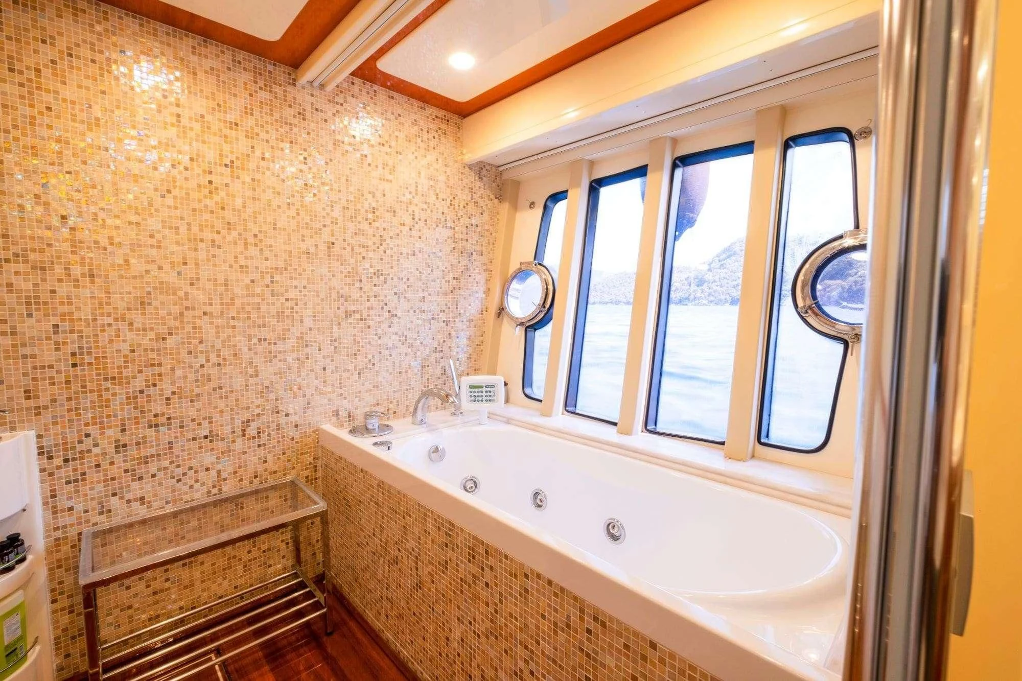 a bathroom with a tub and a bench aboard ASTARTE Yacht for Sale