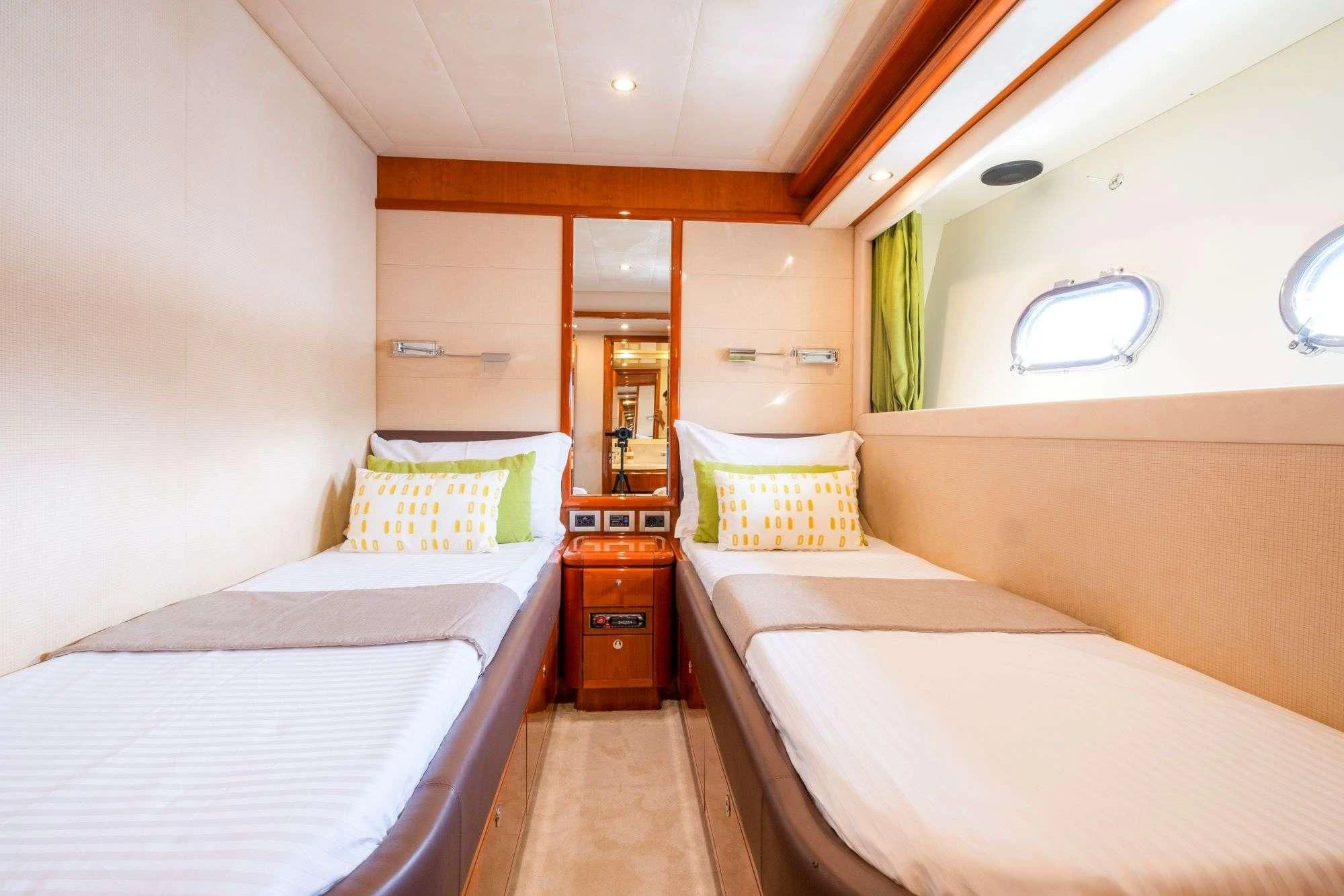 a room with beds and a mirror aboard ASTARTE Yacht for Sale