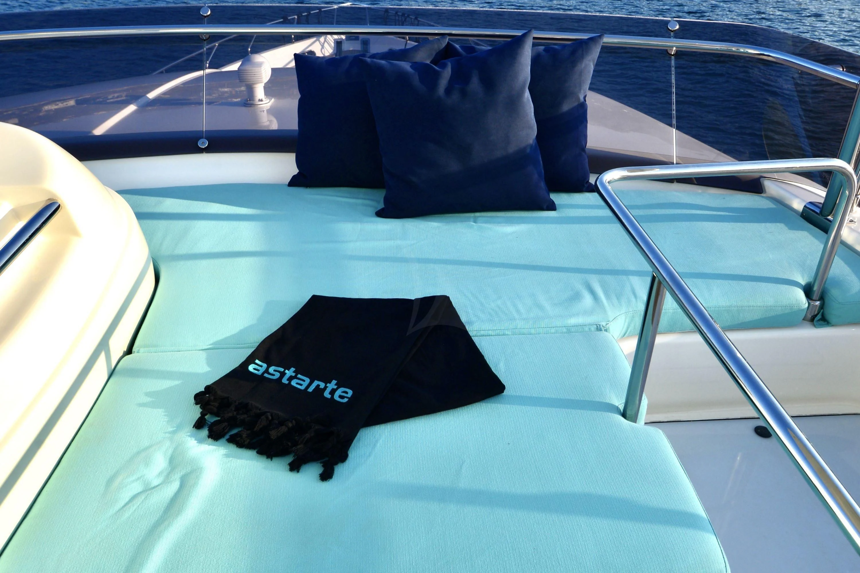 a black pillow on a white table aboard ASTARTE Yacht for Sale