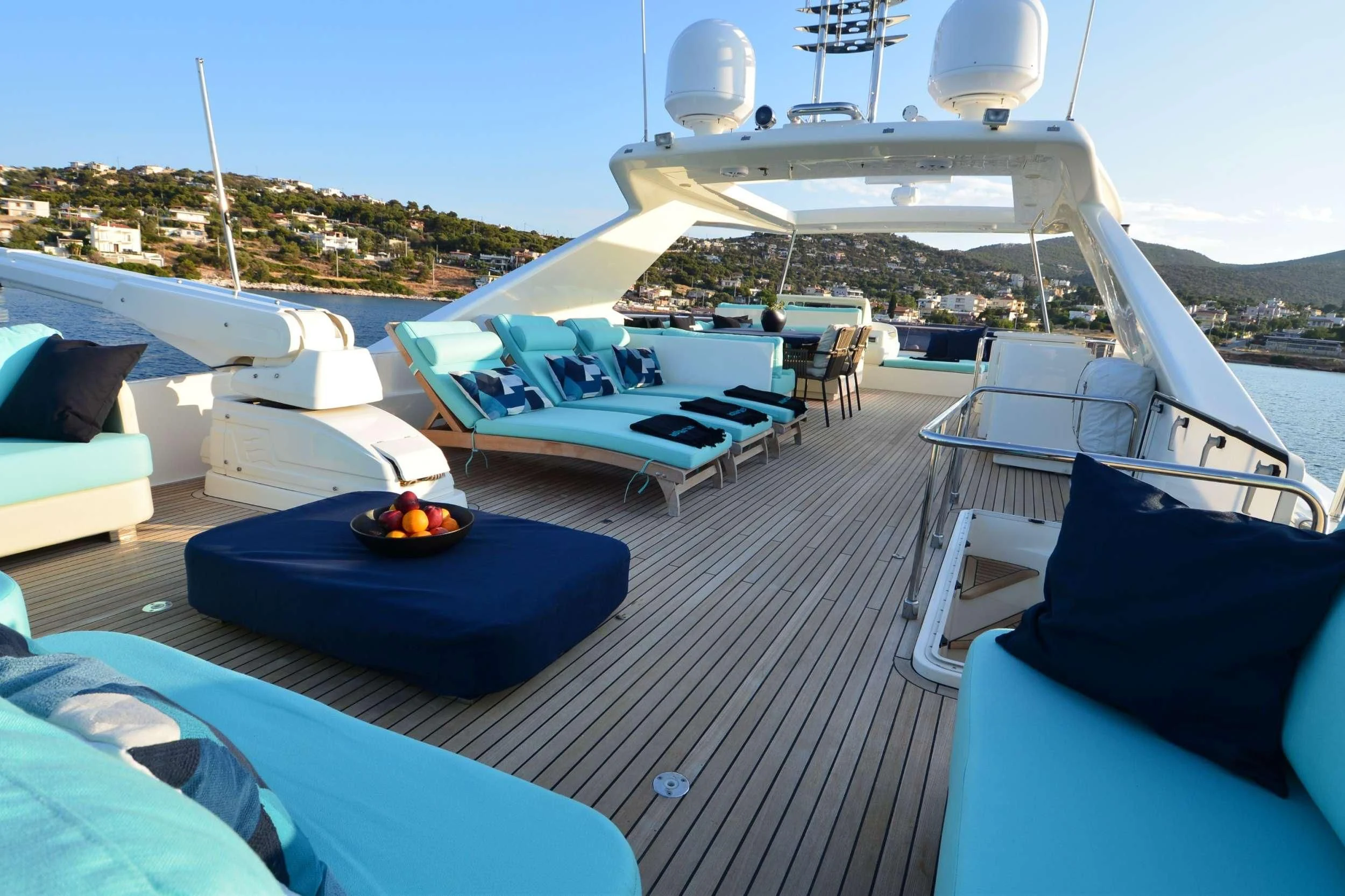 a deck with lounge chairs and a pool with a view of a city aboard ASTARTE Yacht for Sale