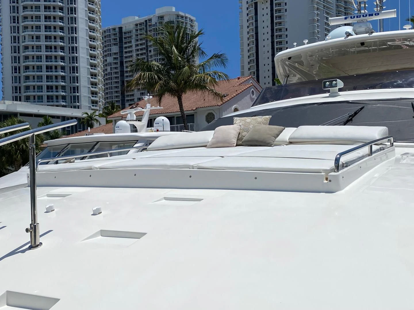 a white boat on a beach aboard ADAR Yacht for Sale