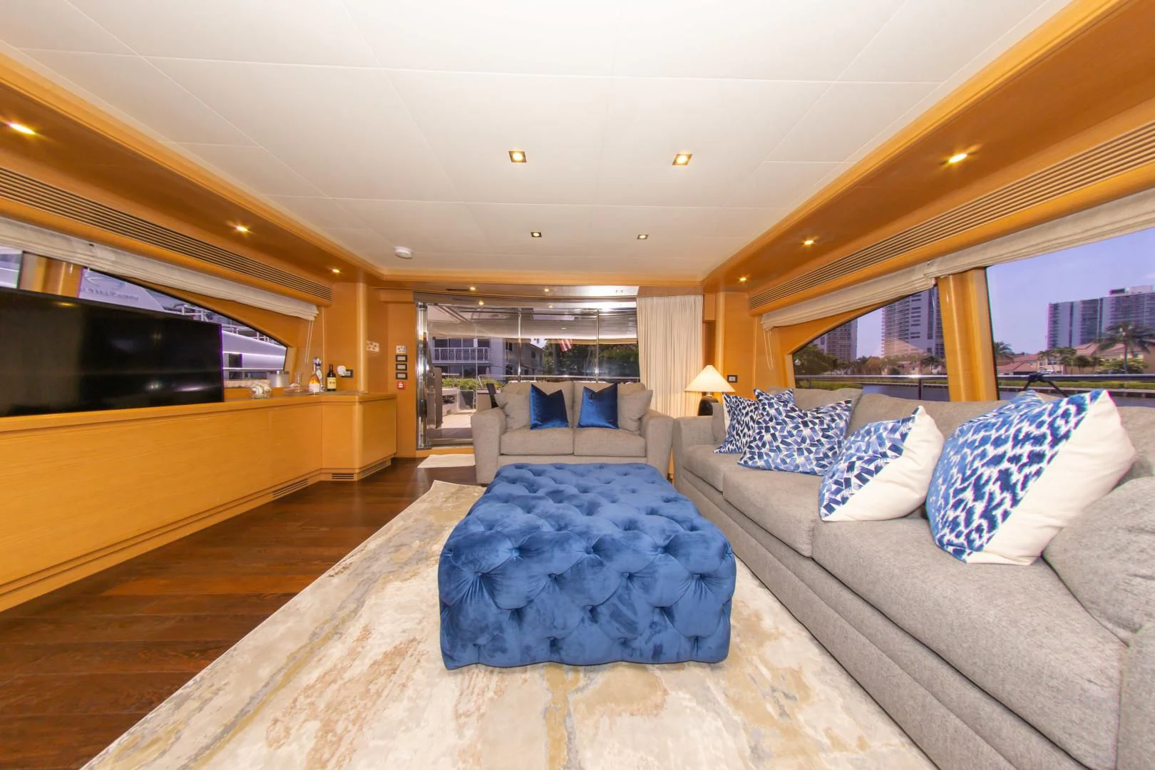 a large living room with a large blue rug aboard ADAR Yacht for Sale