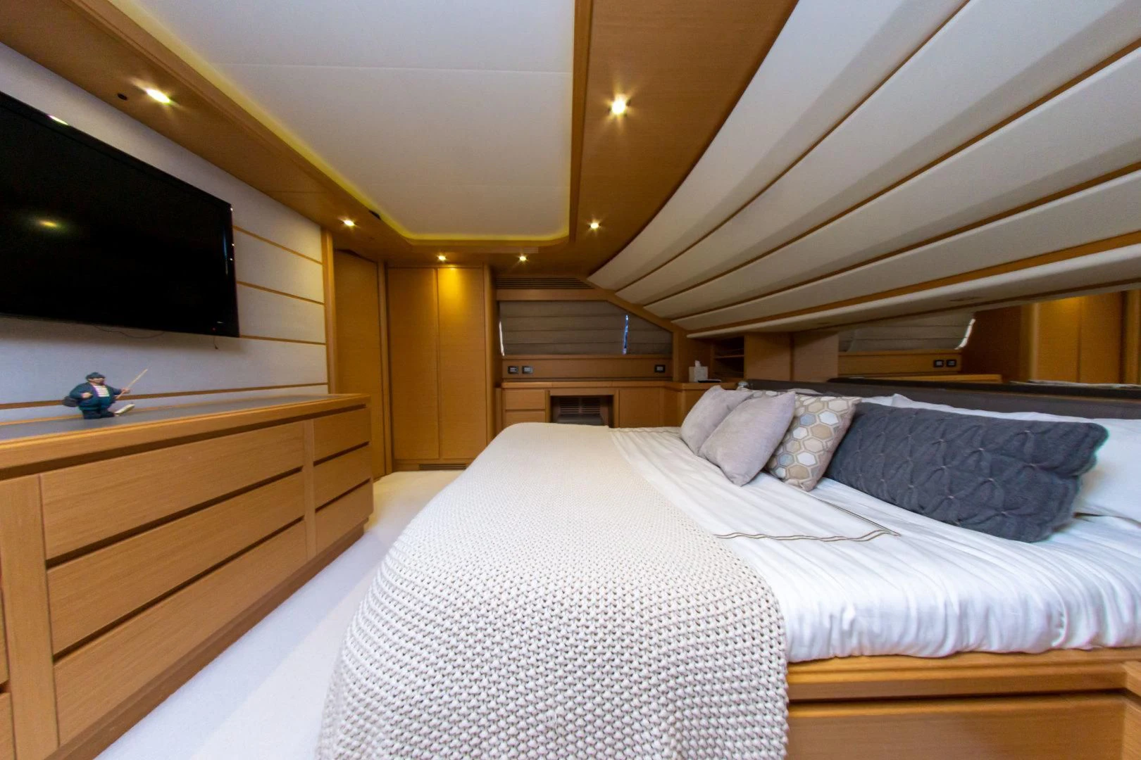 a bed with white sheets aboard ADAR Yacht for Sale