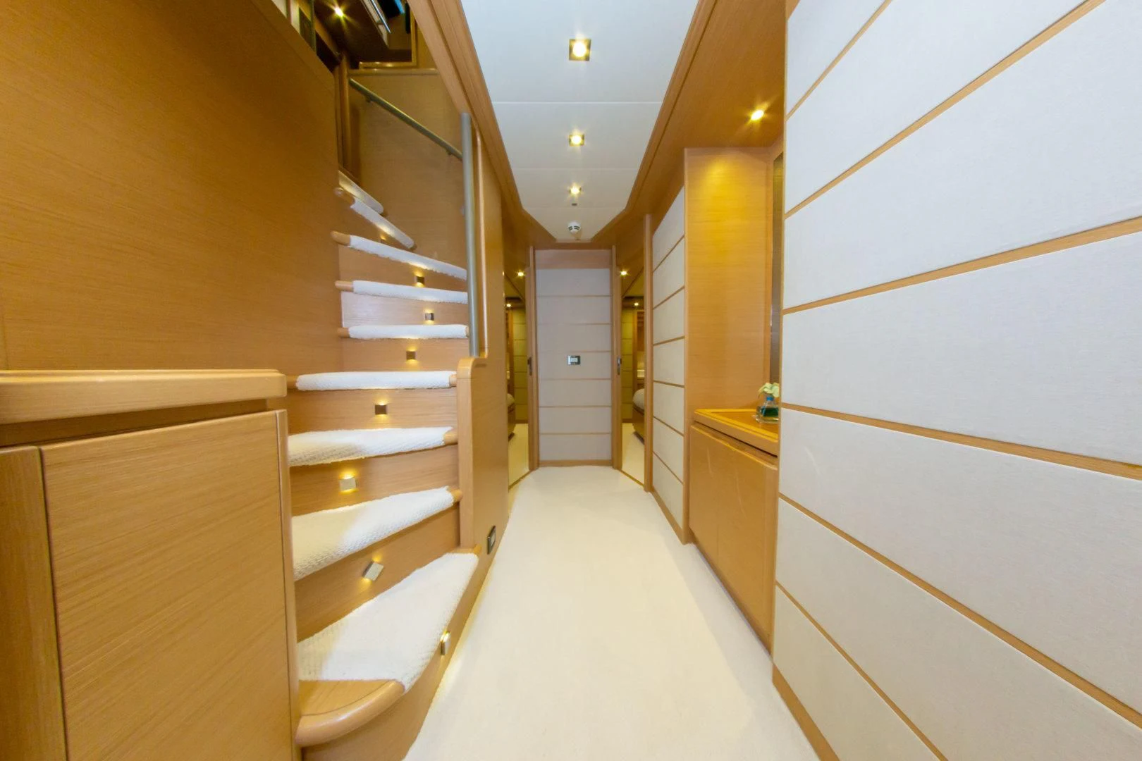 a hallway with a white floor and a white toilet aboard ADAR Yacht for Sale