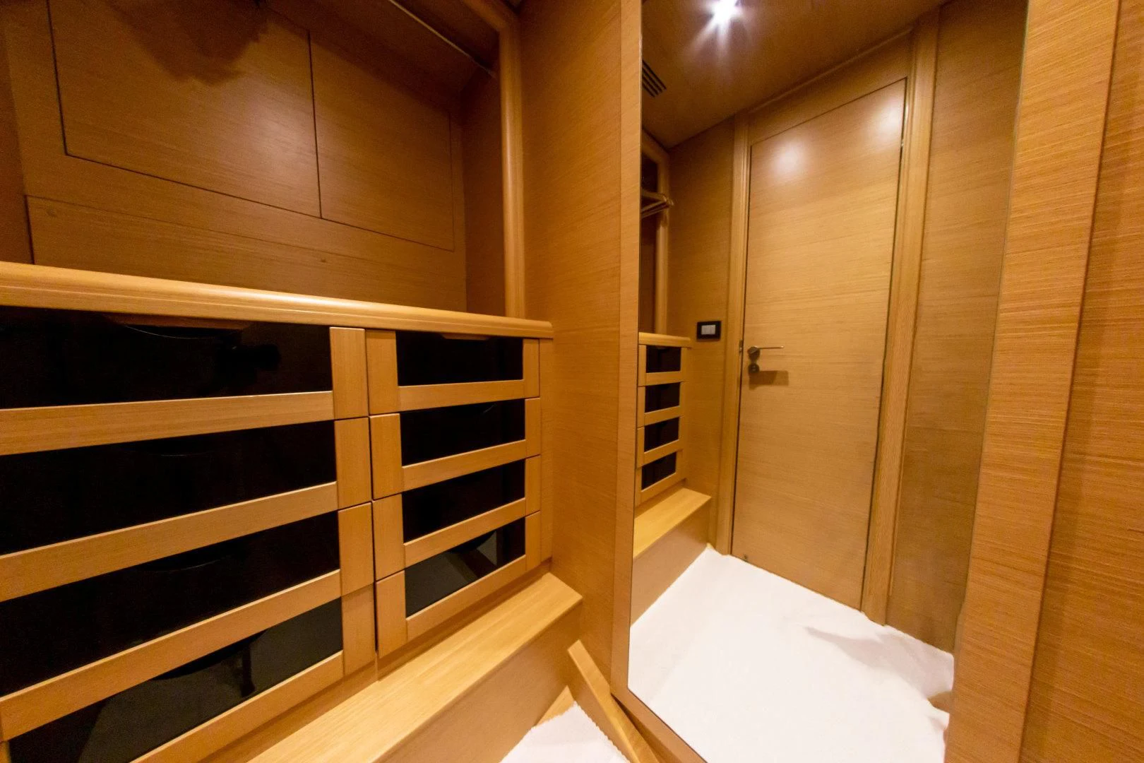 a room with a bed and a closet aboard ADAR Yacht for Sale