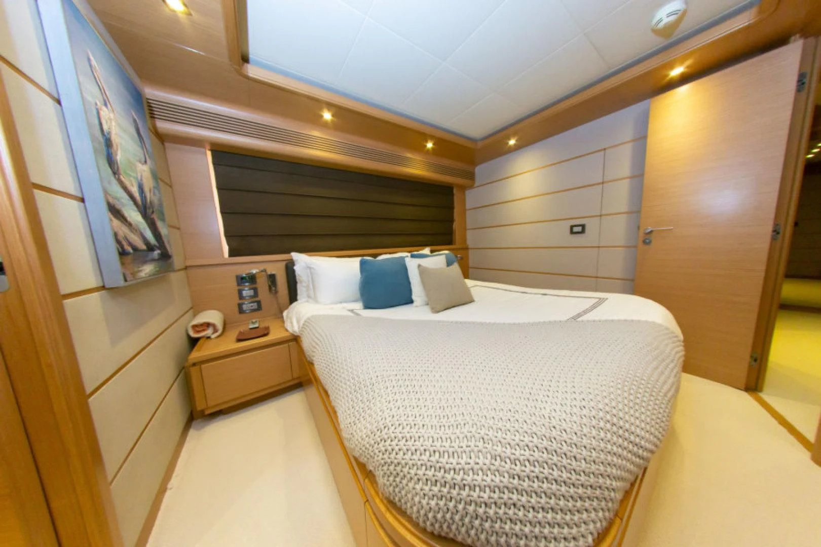 a room with a bed and a dresser aboard ADAR Yacht for Sale